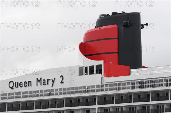 The picture shows the smokestack of the Queen Mary 2, white and red, in front of a cloudy sky, Hamburg, Hanseatic City of Hamburg, Germany, Europe