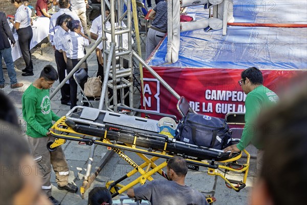 Oaxaca, Mexico, Emergency medical technicians bring in a stretcher and medical equipment in case it is needed during youth boxing matches, Central America