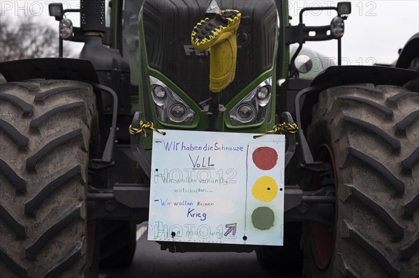A demonstration sign mounted on a tractor, vehicles block the Strasse des 17. Juni, taken as part of the 'AeoeBauern-Proteste'Aeo in Berlin, 22/03/2024