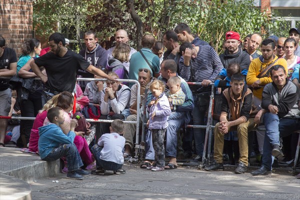 Refugees from Syria wait behind barriers in the central reception centre for asylum seekers at the State Office for Health and Social Affairs in Berlin, 26/08/2015