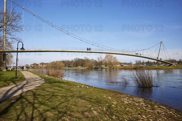 The curved suspension bridge designed by Joerg Schlaich, called Glacisbruecke, crosses the Weser near Minden, Muehlenkreis Minden-Luebbecke, North Rhine-Westphalia, Germany, Europe