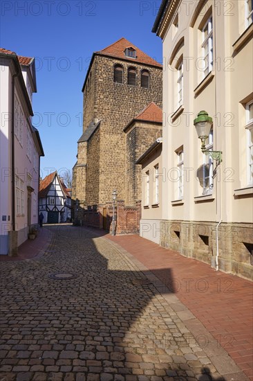 High cobbled street and tower of St Martin's Church in the old town of Minden, Muehlenkreis Minden-Luebbecke, North Rhine-Westphalia, Germany, Europe