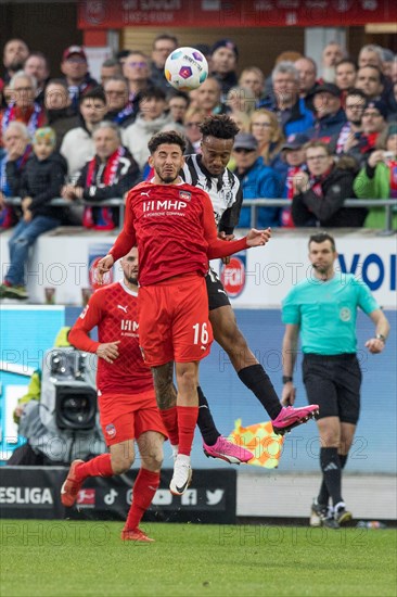 Football match, Kevin SESSA 1.FC Heidenheim in front in aerial combat for the ball with Nathan NGOUMOU Borussia Moenchengladbach, football stadium Voith-Arena, Heidenheim