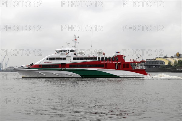 Red and white catamaran on calm waters named 'Halunder Jet', Hamburg, Hanseatic City of Hamburg, Germany, Europe