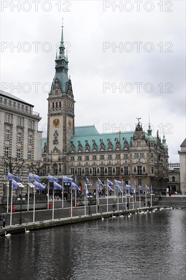 The impressive Hamburg City Hall with tower and flags on the waterfront, Hamburg, Hanseatic City of Hamburg, Germany, Europe