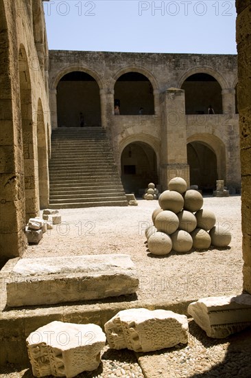 Stone sling shot balls, courtyard, Archaeological museum, Rhodes, Greece, Europe