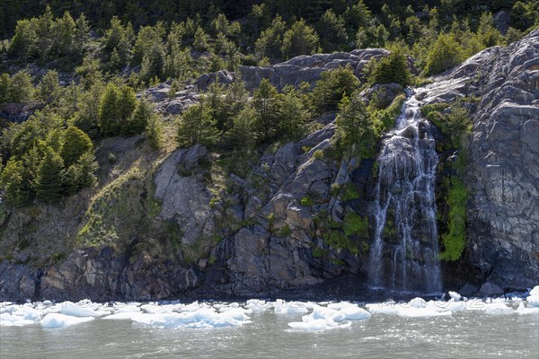 Waterfall, floating ice, Lago Grey, Torres del Paine National Park, Parque Nacional Torres del Paine, Cordillera del Paine, Towers of the Blue Sky, Region de Magallanes y de la Antartica Chilena, Ultima Esperanza Province, UNESCO Biosphere Reserve, Patagonia, End of the World, Chile, South America