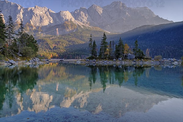 Mountain lake in front of steep mountains, reflection, evening light, autumn, Eibsee lake, view of Zugspitze, Bavaria, Germany, Europe