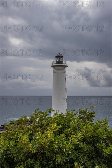 Le Phare du Vieux-Fort, white lighthouse on a cliff. Dramatic clouds with a view of the sea. Pure Caribbean on Guadeloupe, French Antilles, France, Europe