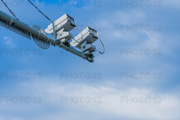 Speed radar cameras mounted on metal pole against blue sky with puffy white clouds in Daejeon, South Korea, Asia