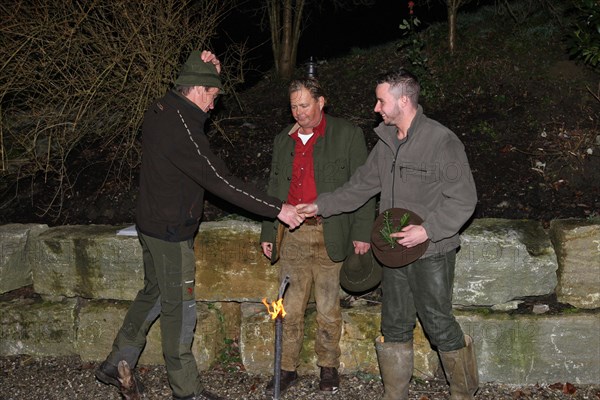 Wild boar (Sus scrofa) Hunting guide presents hunter with a gun after the hunt, tradition, Allgaeu, Bavaria, Germany, Europe