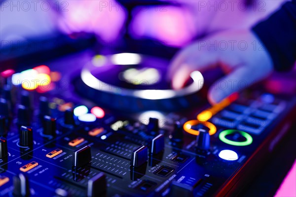 Hand of a DJ on a mixing desk, also called DJ controller or DJ console, at a party, Cologne, North Rhine-Westphalia, Germany, Europe