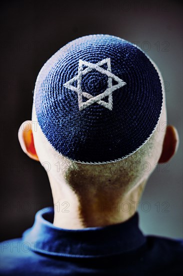 Jewish man wearing a kippa with a Star of David on his head, back view, studio shot, Germany, Europe