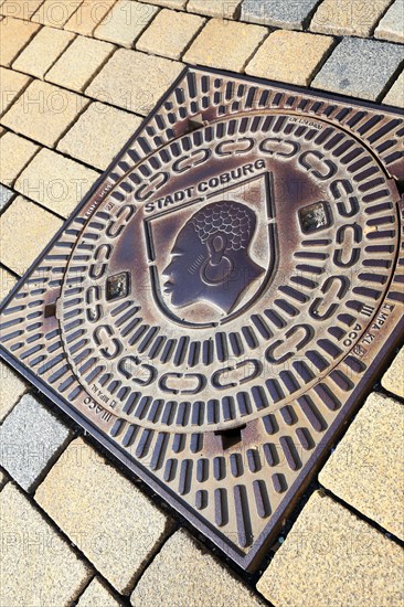 The historic old town centre of Coburg with a view of the manhole cover with coat of arms. Coburg, Upper Franconia, Bavaria, Germany, Europe