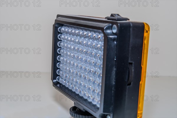 Closeup of LED continuous photographic light on white background. Selective focus on rear row of lights