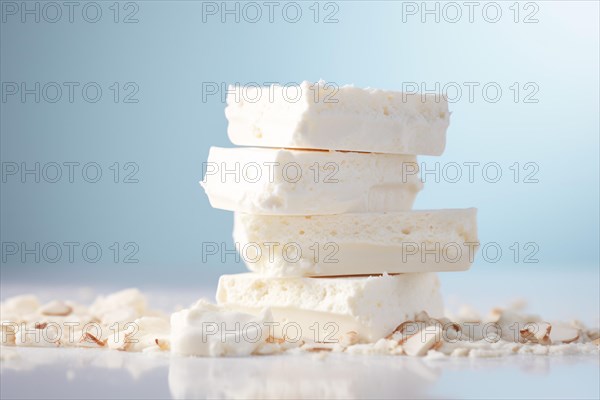 STack of white nougat on pastel blue studio background. KI generiert, generiert, AI generated