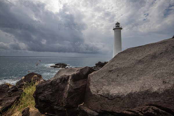 Le Phare du Vieux-Fort, white lighthouse on a cliff. Dramatic clouds with a view of the sea. Pure Caribbean on Guadeloupe, French Antilles, France, Europe