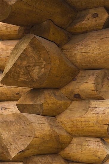Stacked Eastern White pine logs forming the exterior corner walls on a luxurious Scandinavian style log home, Quebec, Canada, North America