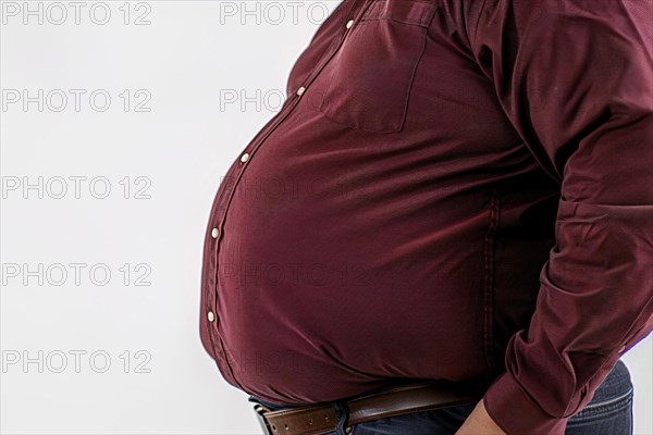 Close up of fat belly of heavily obese man in red shirt on white background. KI generiert, generiert, AI generated