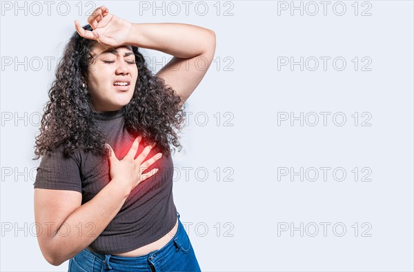 People with heart problems isolated. Latin woman with heart pain on isolated background. Young woman with tachycardia