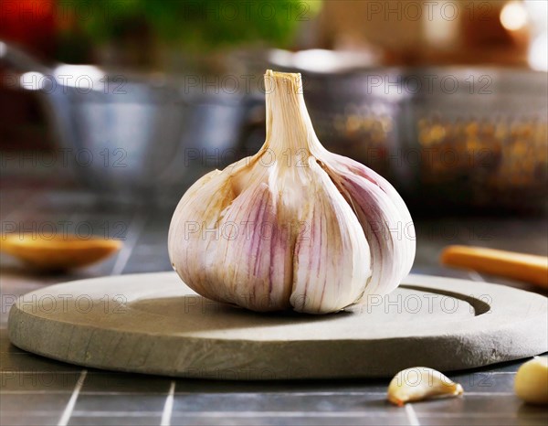Food, spice, garlic, a whole garlic bulb next to a single clove on a rustic wooden surface, AI generatedFood, spice, Allium sativum, AI generated, AI generated