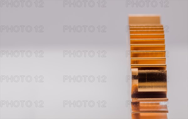 Closeup of copper computer heat sink fins on white background