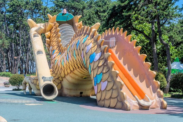 A large dragon-shaped play structure with slides in an outdoor playground, in Ulsan, South Korea, Asia
