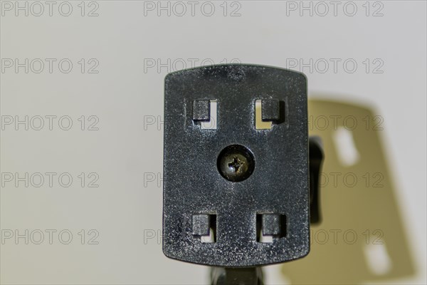 Closeup of car navigation mounting plate and its shadow on white background