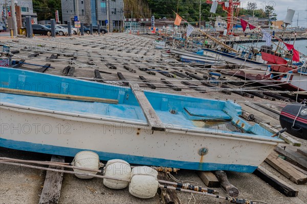 Fishing boats in dry dock with ropes and buoys, awaiting the return to water, in Ulsan, South Korea, Asia