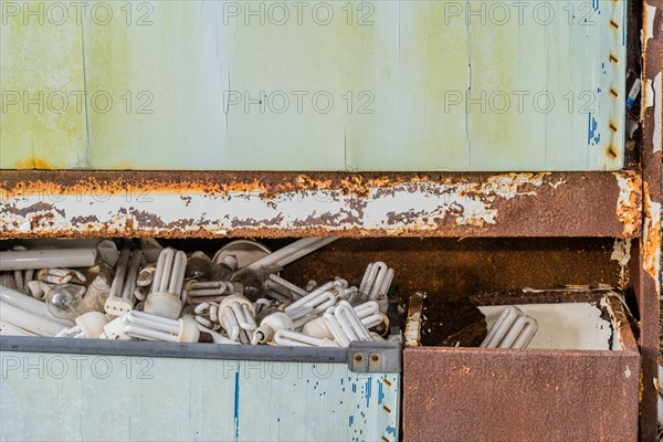 A collection of expired light bulbs stored in a rusted metal cabinet, in South Korea