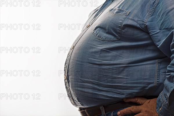 Close up of fat belly of heavily obese man in shirt on white background. KI generiert, generiert, AI generated