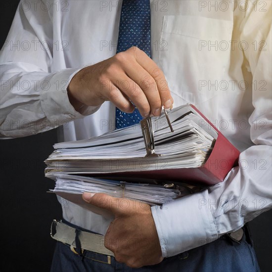 A man in formal attire holds an overstuffed briefcase, symbolism bureaucracy, AI generated, AI generated