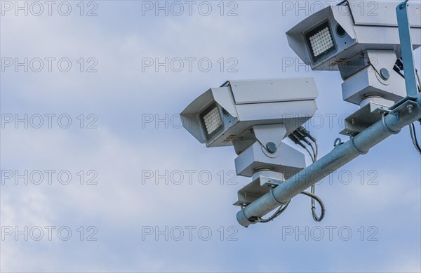 Speed radar cameras mounted on metal pole against blue sky with puffy white clouds in Daejeon, South Korea, Asia