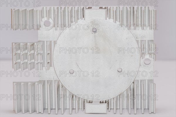 Closeup of fins and fan mounting surface of rectangle aluminum heat sink on white background