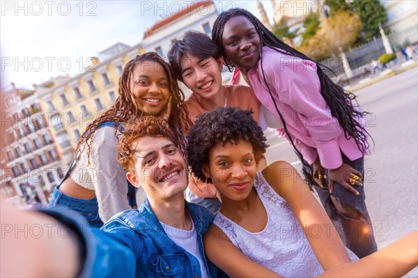 Personal perspective of a multi-ethnic group of friends taking a selfie in the city