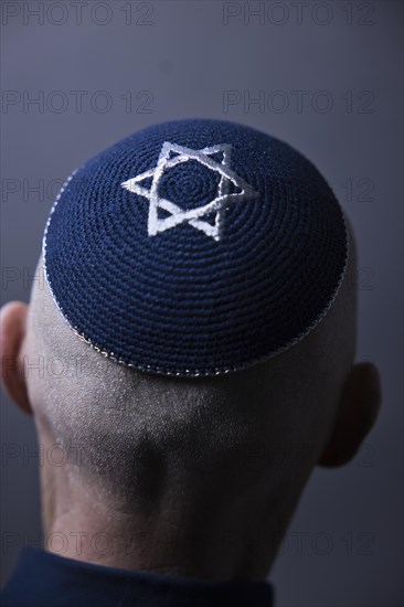 Jewish man wearing a kippa with a Star of David on his head, back view, studio shot, Germany, Europe