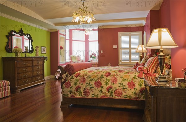 Wooden sleigh bed and night table, dresser in master bedroom on upstairs floor inside elegant style home, Quebec, Canada, North America