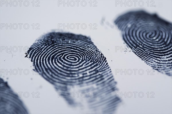 Black fingerprints on white paper background. KI generiert, generiert, AI generated