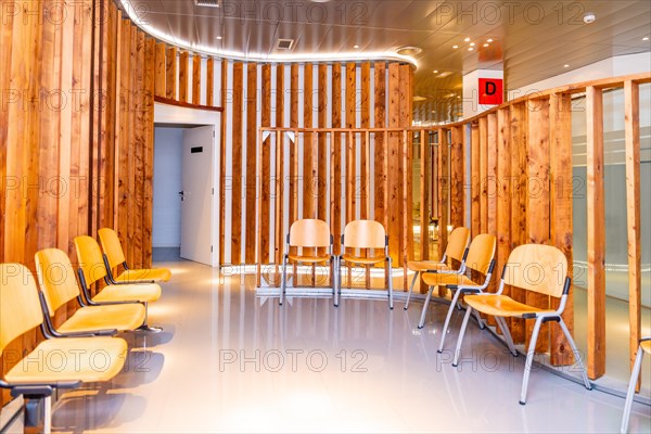 Empty waiting room of a ophthalmology clinic with chairs and wooden furniture