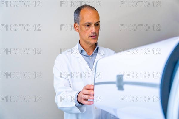 Ophthalmologist preparing an innovative laser machine to treat patients with glaucoma