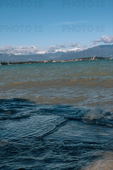 View over the wavy Lake Garda under a blue sky with clouds, Sirmione, Lake Garda, Italy, Europe