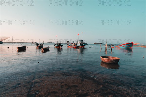 Scenic view of traditional Vietnamese fishing boats in Phan Thiet fishing village in Mui Ne, Vietnam, Asia