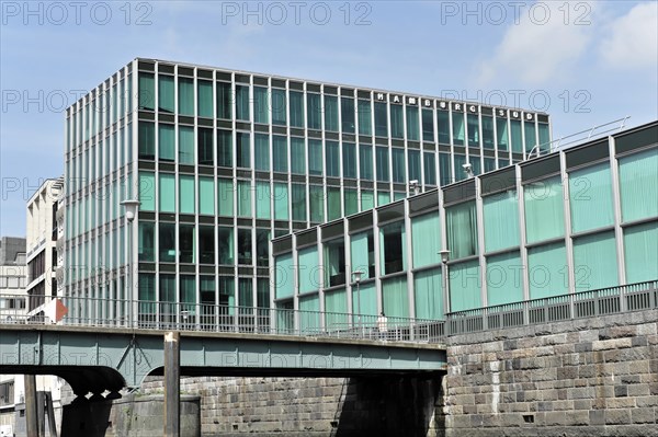 Hamburg Sued Reederei, A building with a green glass facade stands next to a bridge in an urban environment, Hamburg, Hanseatic City of Hamburg, Germany, Europe