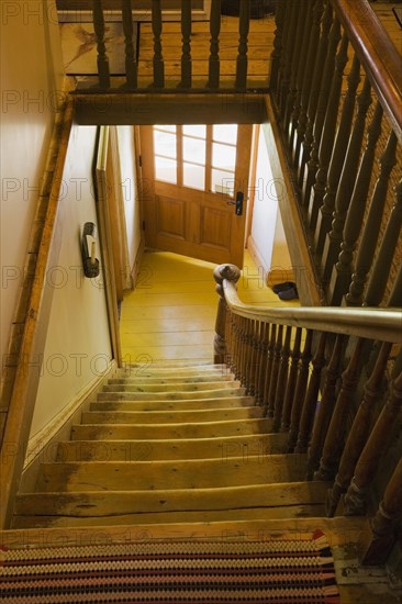 Railings on upstairs floor hallway and staircase leading to downstairs floor inside old 1838 house, Quebec, Canada, North America