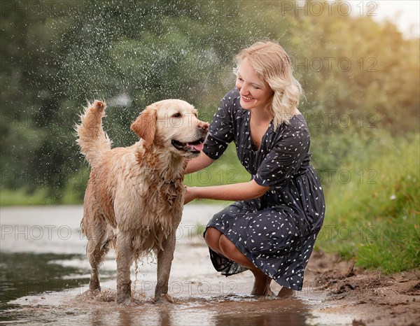 Labrador dog dirty muddy wet, shaking next to a woman in a dark summer dress, AI generated, AI generated