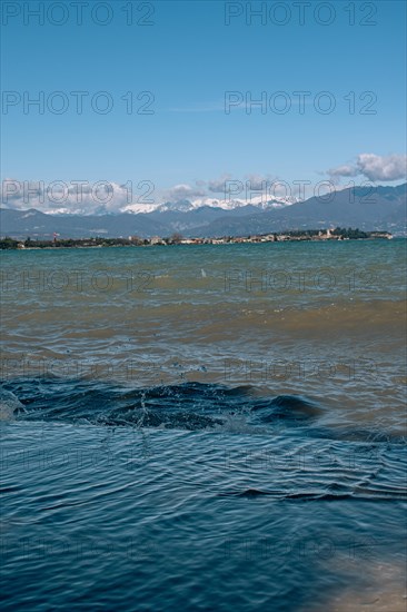 View over the wavy Lake Garda under a blue sky with clouds, Sirmione, Lake Garda, Italy, Europe
