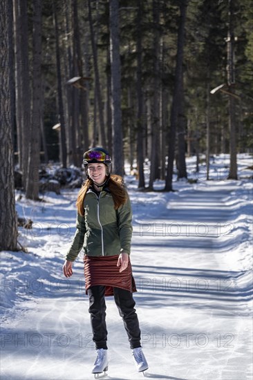 Ice skater, ice path through the forest, Sur En, Sent near Scuol, Engadin, Switzerland, Europe