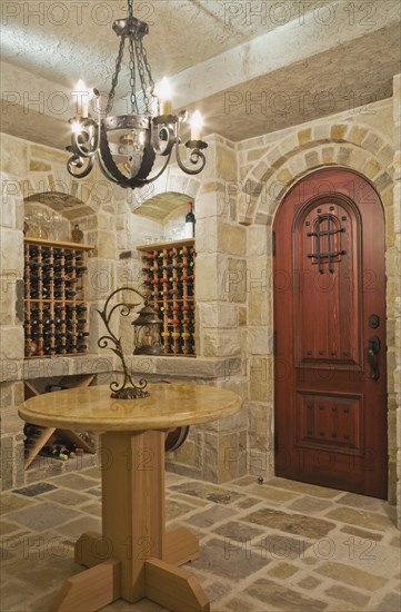 Medieval style beige and tan cut stone wine cellar in basement inside elegant style home, Quebec, Canada, North America