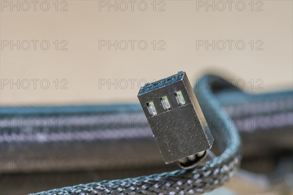 Close-up of a USB plug with metallic and black color scheme, in South Korea