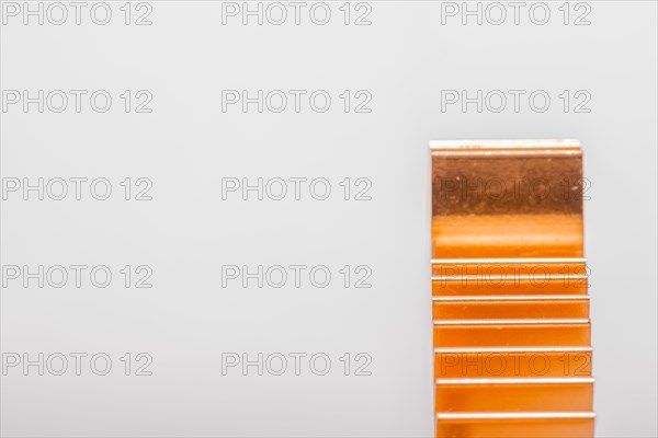 Closeup of copper computer heat sink fins on white background